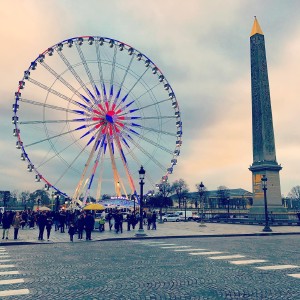 An obelisk and a ferris wheel